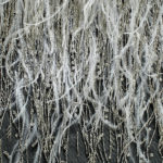 Hand beaded bridal design using stones, feathers, beads