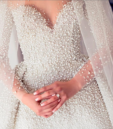 Hand beaded bridal gown made entirely of pearls and tiny crystals delicately stitched onto a tulle base by Ricamour
