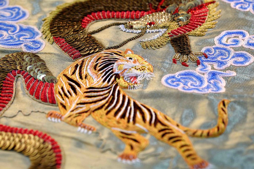 Hand beaded dragon and tiger for a couture garment by Ricamour