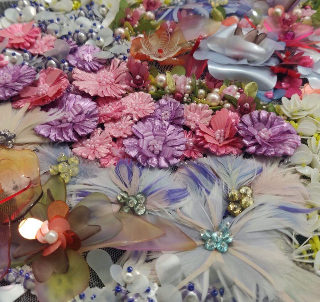 3D couture design with flowers of different colours and techniques with pearls
