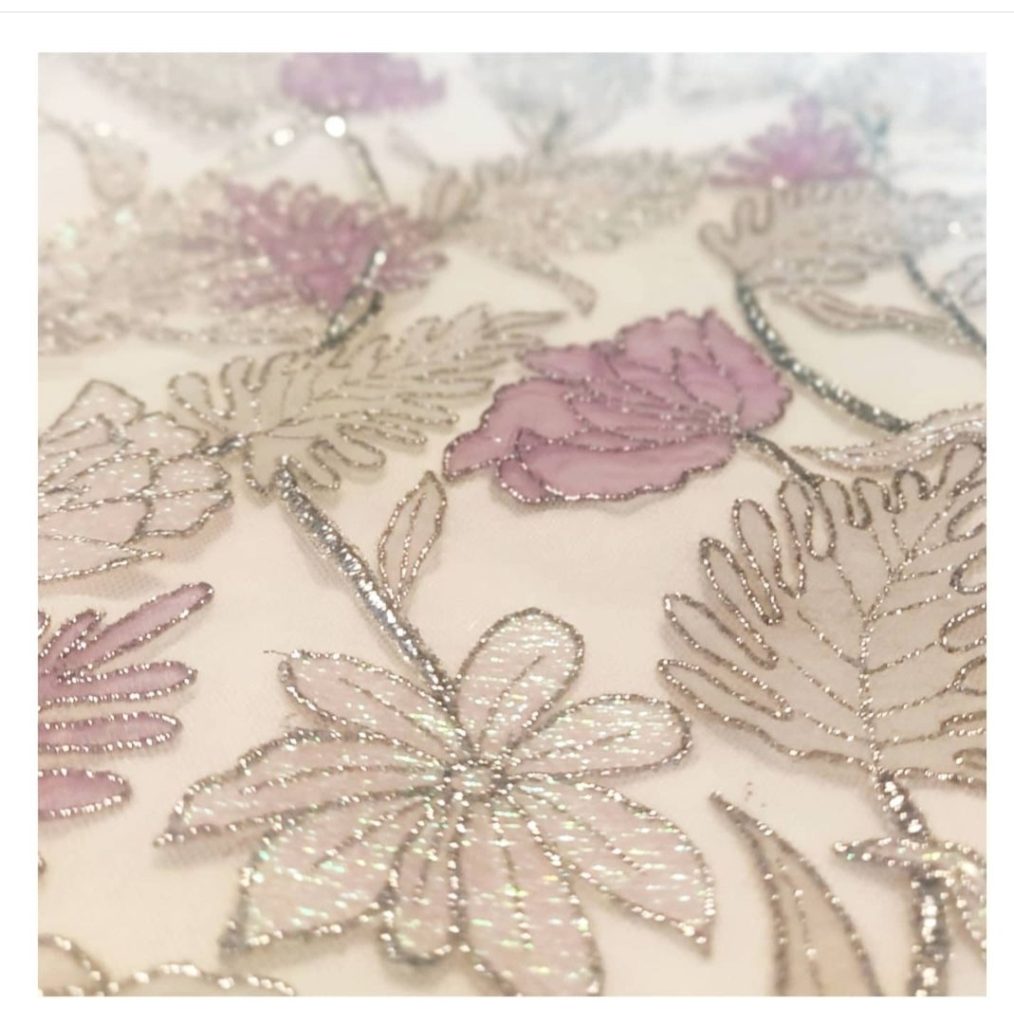 Floral design appliquéd with iridescent fabrics for dreamy bridal gown