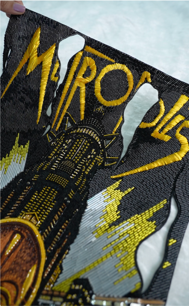 Metropolis poster hand-embroidered by Ricamour. Thread work, beaded textures, bespoke art for luxury spaces. 