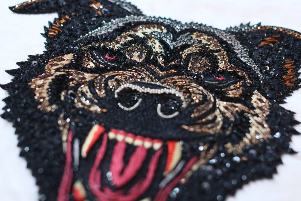 A hand-beaded dog face by Ricamour